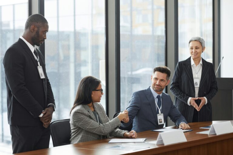 Mid-market leadership team collaborating around conference table showcasing partnerships