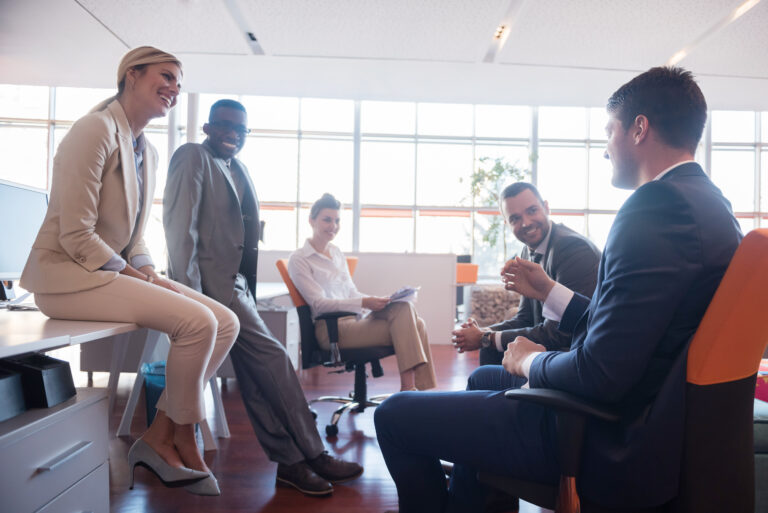 Mid-market leadership team in open AI conversation about AI strategy around conference table